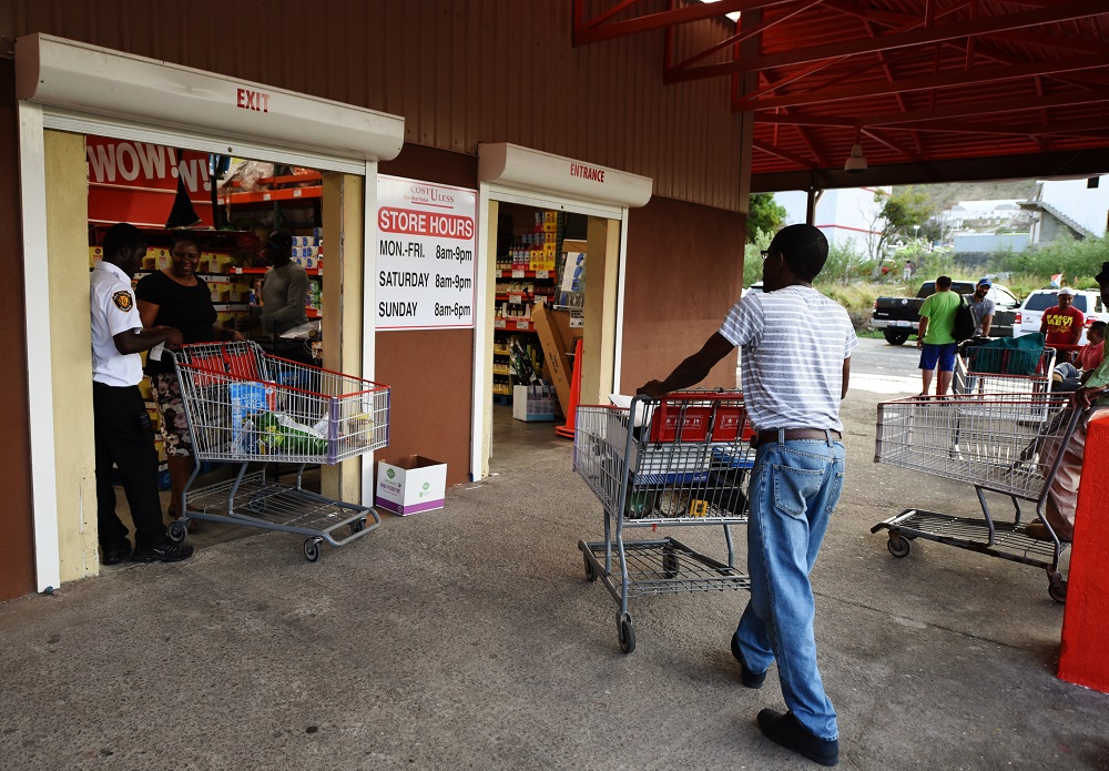 Cost-U-Less,the warehouse superstore, officially reopens on Saturday, Sept. 1, nearly a year after being destroyed by Hurricane Irma and then plundered in the looting that following. Here, shoppers outside the store on Wednesday, Aug. 29.