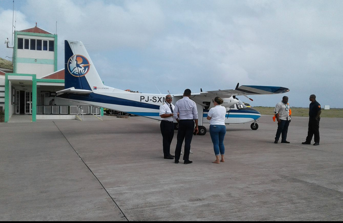 SXM Airways BN Islander aircraft parked at Saba Airport with pilot pax