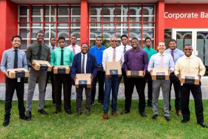 Male staff members at CIBC FirstCaribbean Philipsburg Branch receiving gifts of appreciation for their positive contributions.
